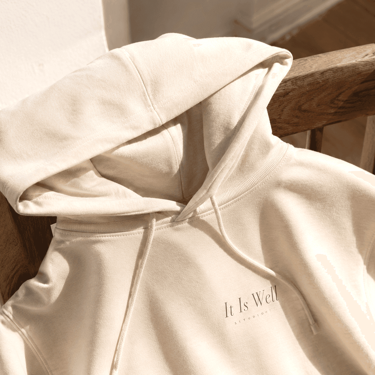 Close detail of It Is Well hoodie chest print