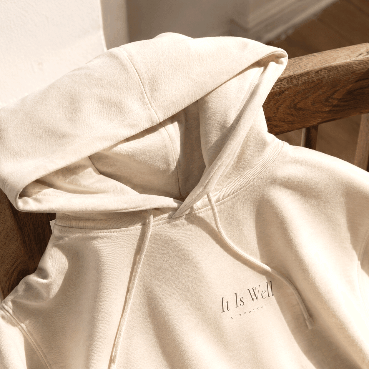 Close detail of It Is Well hoodie chest print