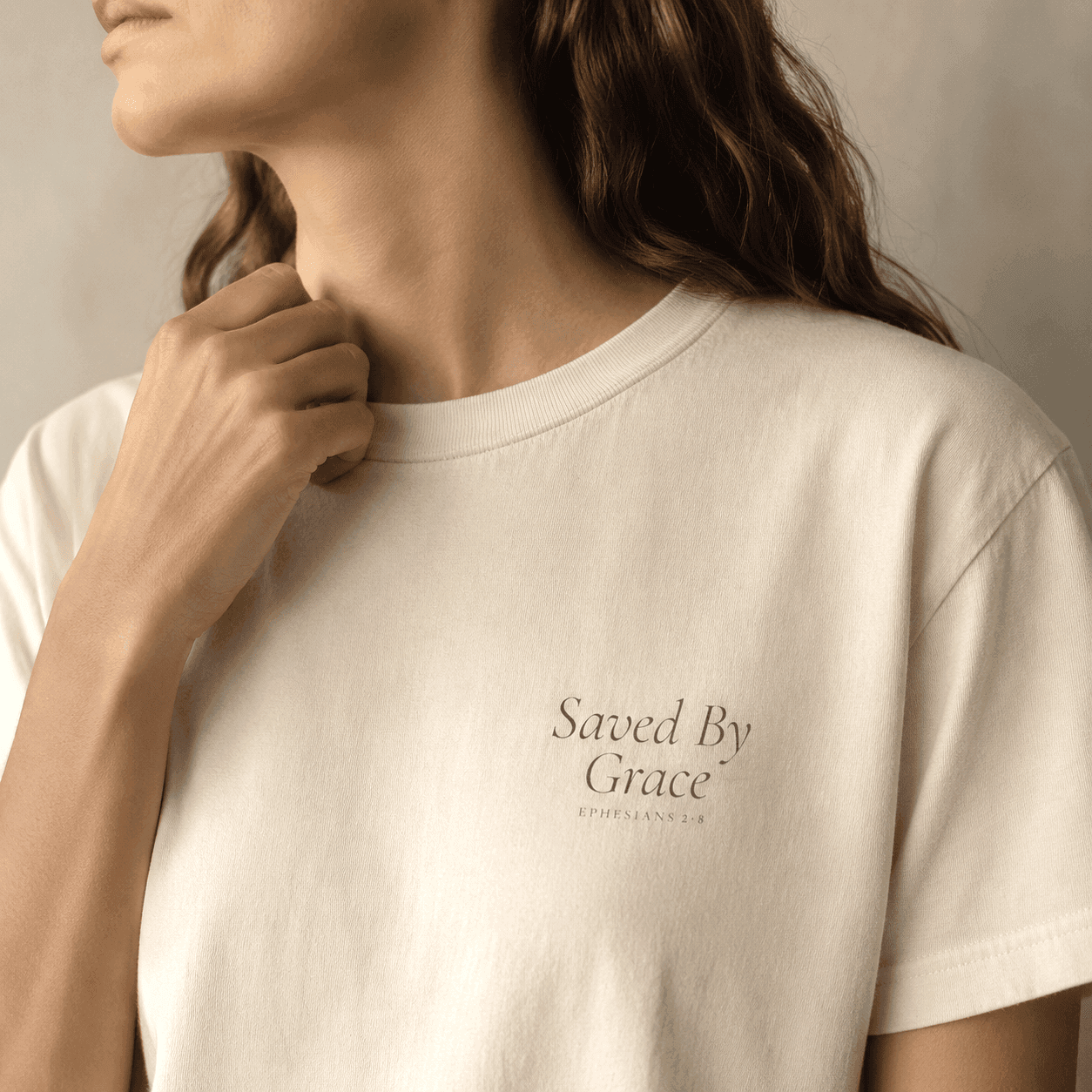 Close detail of Saved By Grace print on a light garment
