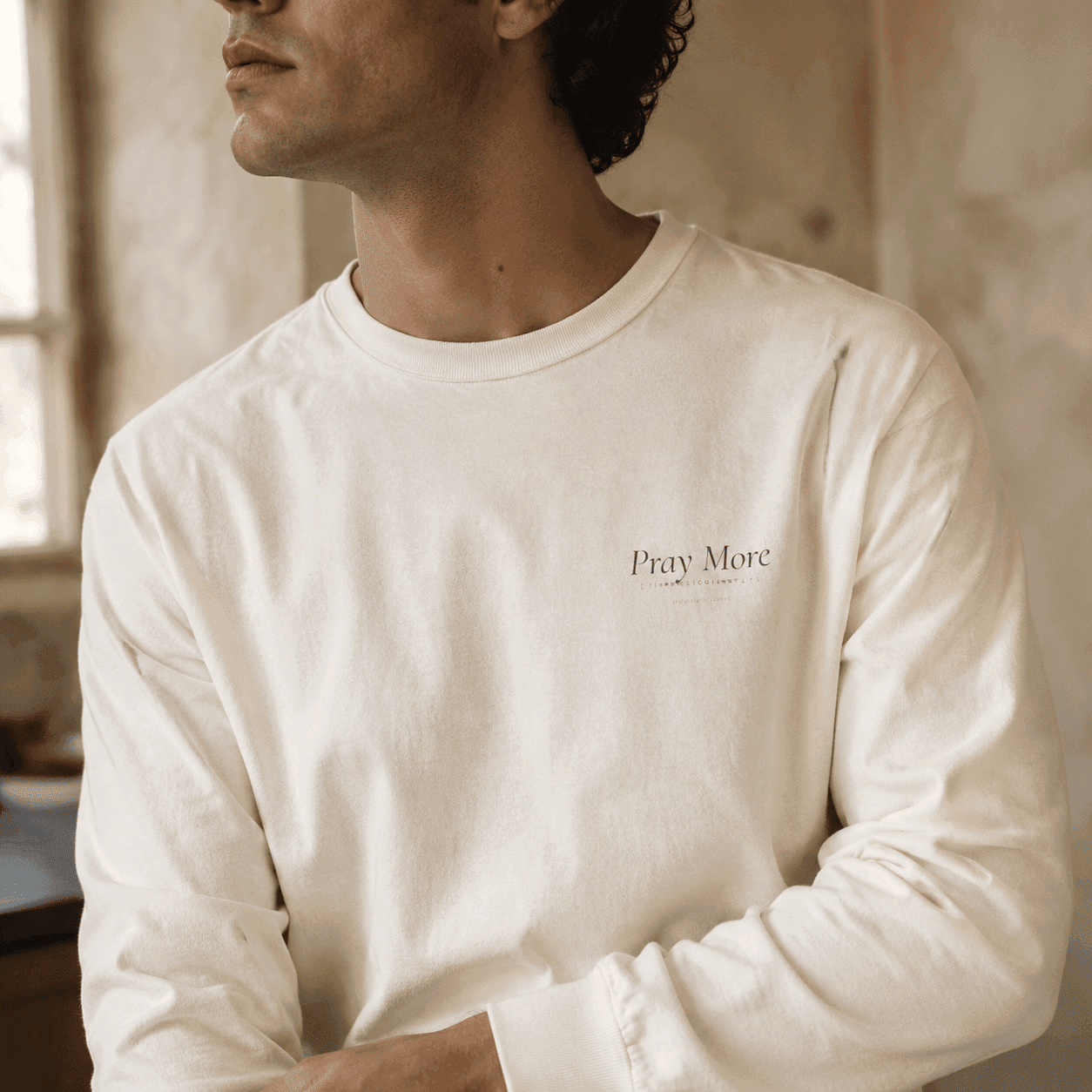 Close detail of Pray More long sleeve print