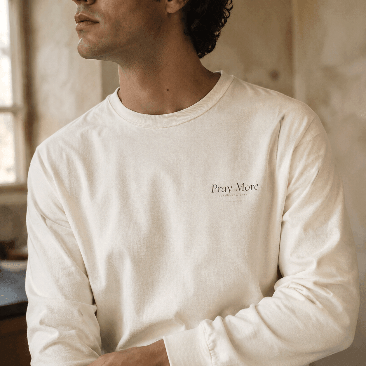 Close detail of Pray More long sleeve print